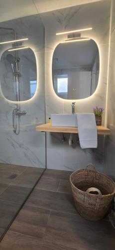 a bathroom with a sink and a mirror at Νηρηίδες Apartments Studios in Kyparissia