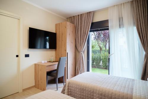 a bedroom with a bed and a desk and a window at Da Niko in Treviso