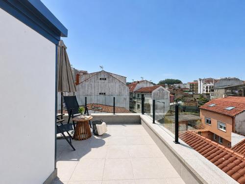 a balcony with a view of a building at Casa PedraMar in O Grove