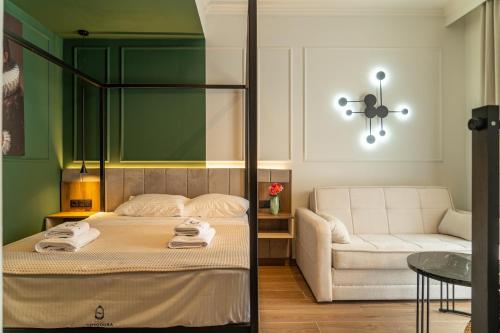 a bedroom with a bed and a couch and a table at Villa Theodora Boutique Stay in Fanari