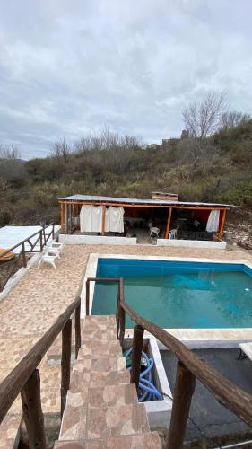 a house with a swimming pool and a building at Terrazas Jorge y Claudia in Bialet Massé