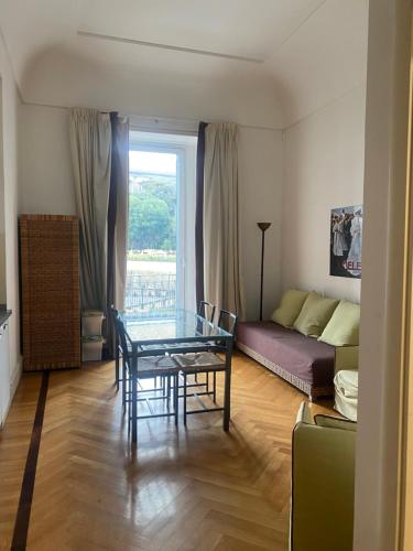 a living room with a glass table and a couch at Residence gli Angioini srl in Naples