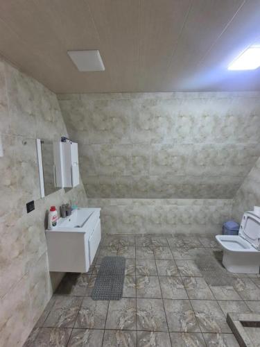 a bathroom with a sink and a toilet at Eco Villa, A frame with barbecue zone and pool in Yerevan