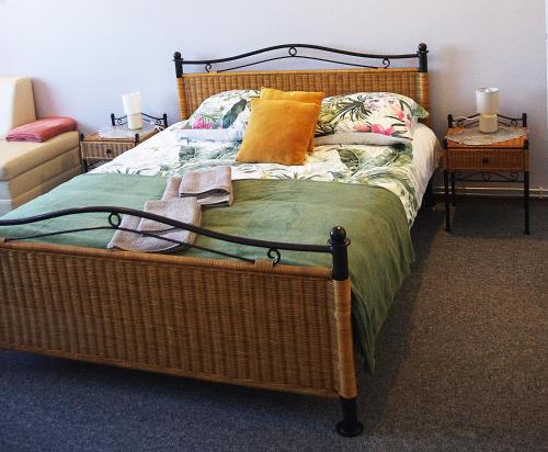 a bed with a wooden frame and pillows on it at Laskowy Sad pokoje gościnne agroturystyka in Wieniec