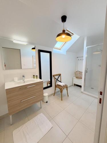 a bathroom with a sink and a mirror at Ty kergo in Surzur