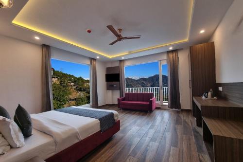 a hotel room with a bed and a balcony at Hotel Luxe Vista Dalhousie in Dalhousie