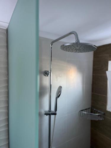 a shower with a shower head in a bathroom at Aegean View House Plomari in Plomari
