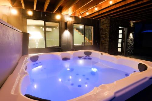 a large bath tub in a room with windows at Whistler Peak Lodge in Glacier