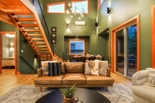 a living room with a couch and a staircase at Whistler Peak Lodge in Glacier
