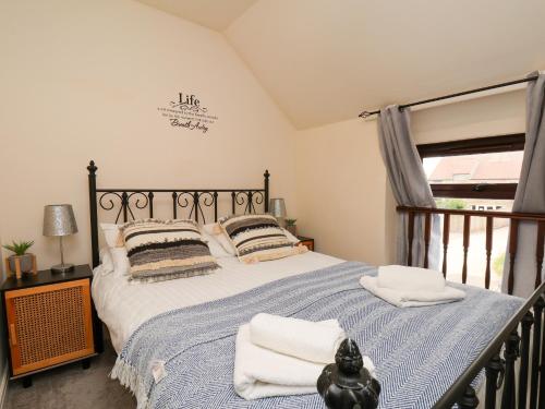 a bedroom with a bed with towels on it at Granary in Pickering