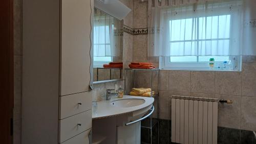 a bathroom with a sink and a window at Haus Margit in Schlierbach