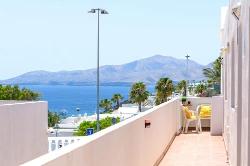 a balcony with a view of the ocean at Apartamentos Bellavista in Puerto del Carmen