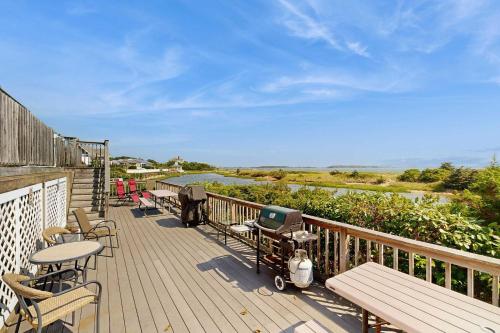 a deck with chairs and tables and a view of the ocean at The Atlantic in Yarmouth