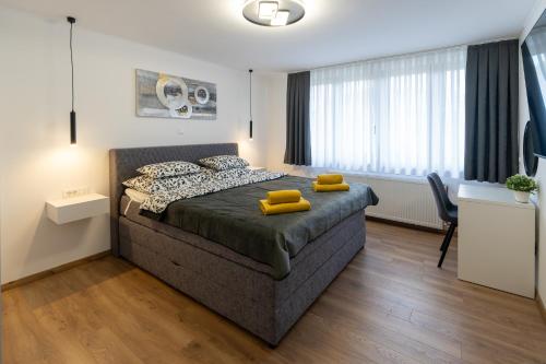 a bedroom with a bed with yellow pillows on it at The Nest Otočac in Otočac