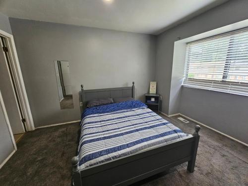 a bedroom with a bed and a window and a mirror at Cozy place! in Baltimore