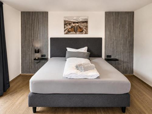 a bedroom with a large bed with white sheets at Haus am Stein in Stuhlfelden