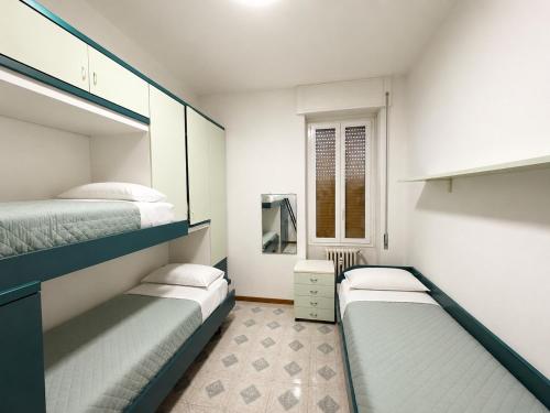 a bedroom with two bunk beds and a window at Apartment house in the center in Oggiono