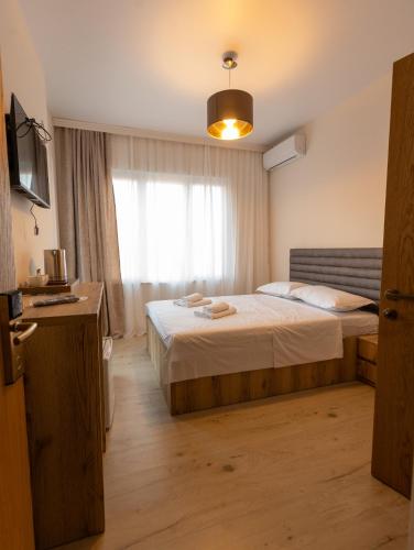 a hotel room with a bed and a window at Mos House in Kobuleti