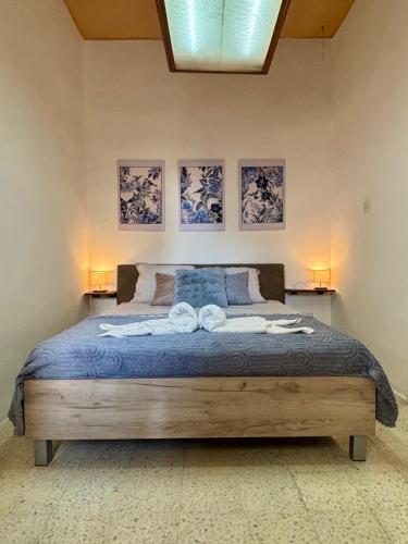 a bedroom with a bed with two towels on it at 166, Rodolfu in Sliema