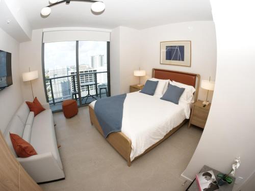 a bedroom with a large bed and a balcony at C5103 Outstanding Studio in the Heart of Downtown in Miami