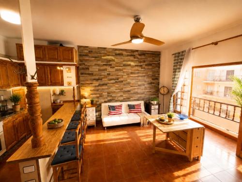 a kitchen and living room with a brick wall at candelaria Quiet 2bedroom Apartment near the Sea FAST WIFI FAST WIFI in Candelaria