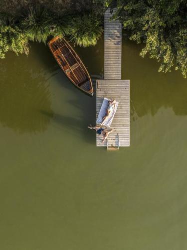two boats sitting on a dock in the water at Forest Camping Resort Blaguš in Sveti Jurij ob Ščavnici