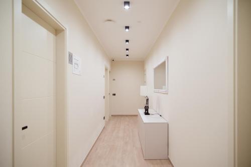 a hallway with white walls and a white sink in a room at Da Niko in Treviso