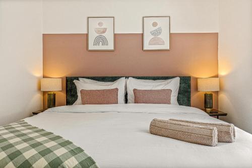 a bedroom with a large white bed with two lamps at Contractor Base Parking 4 Beds Fast Wi-Fi in Bolton upon Dearne