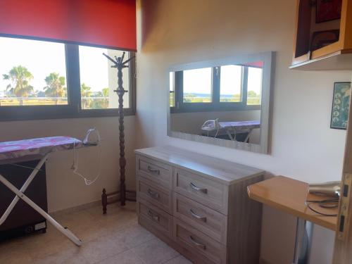 a bedroom with a dresser and a large mirror at VILLA ANTONIS in Kos