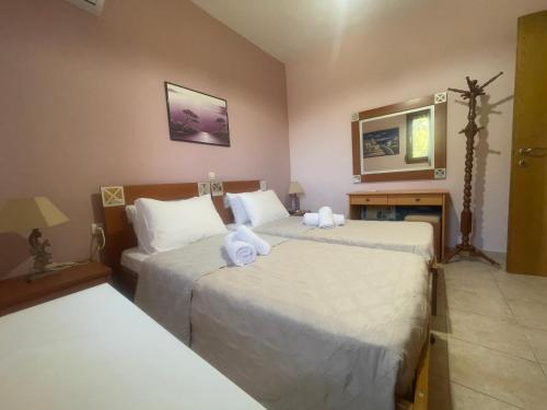 a hotel room with two beds and a couch at VILLA ANTONIS in Kos