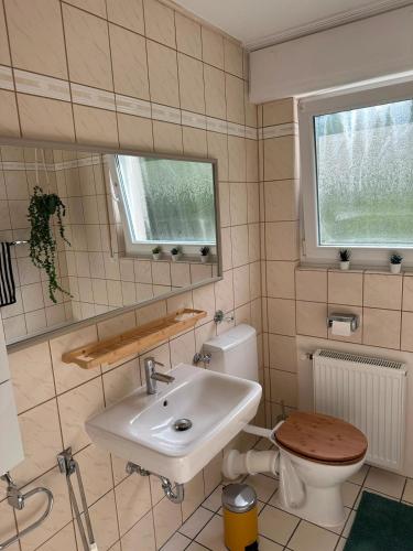 a bathroom with a sink and a toilet at Green View - JK Apartments in Datteln