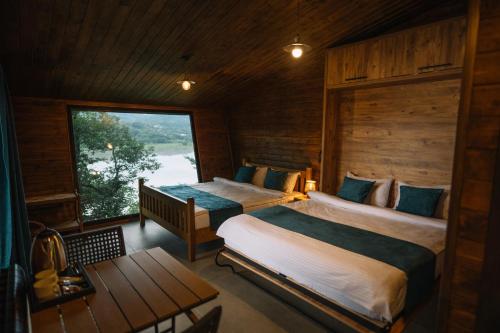 a bedroom with two beds and a window at Porto Gumati in Kutaisi