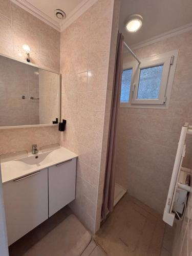 a bathroom with a sink and a mirror at Le Pavillon du Cap d'Antibes in Antibes