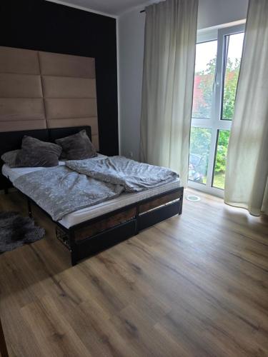 a bedroom with a bed and a large window at Ferienwohnung Engel in Grebenstein