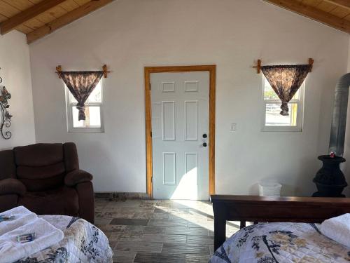 a bedroom with a bed and a chair and a door at #11- Rancho Meling in Camalú