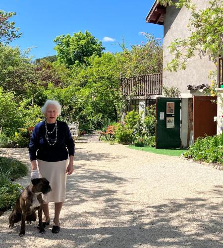 a woman walking a dog on a dirt road at Ma Guitoune in Grenoble