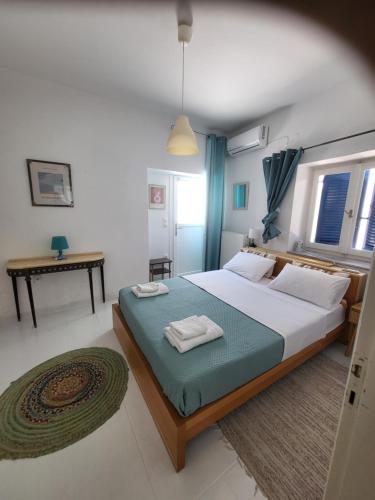 a bedroom with a bed with two towels on it at Manolia Home in Parikia