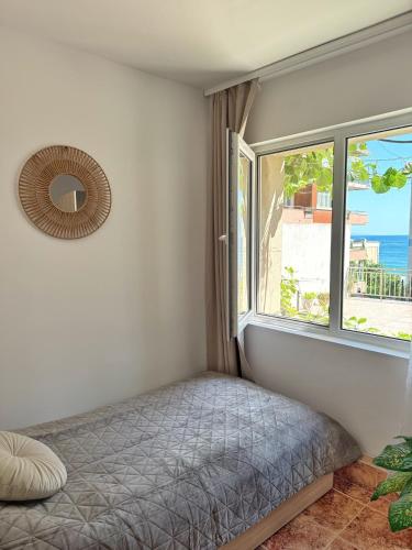 a bedroom with a bed and a window at Nicola`s Apartment in Sozopol