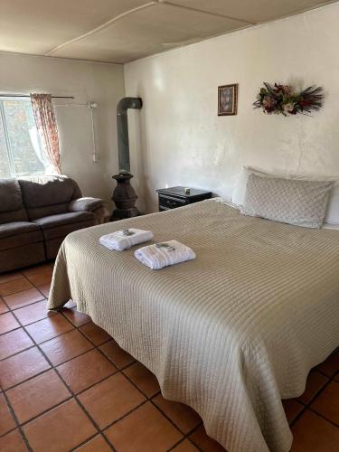 a bedroom with a bed with two towels on it at #5 Rancho Meling in Camalú