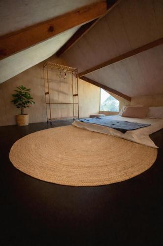 a bedroom with a large rug on the floor at Rodeo Sun Hotel in General Luna