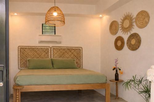 a bed in a room with hats on the wall at Rodeo Sun Hotel in General Luna