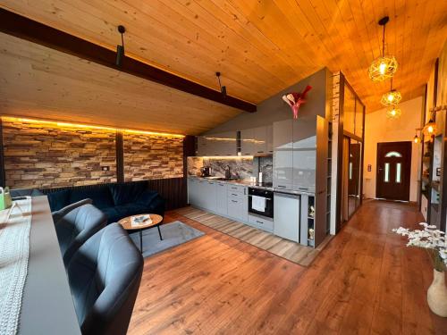 a living room with a couch and a kitchen at Къща за гости Шанови in Gʼovren