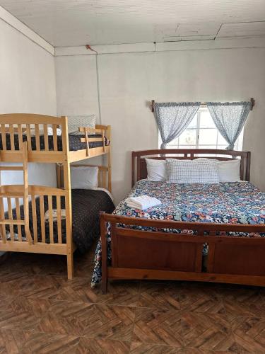 a bedroom with two bunk beds and a ladder at Casa Lizany in Camalú