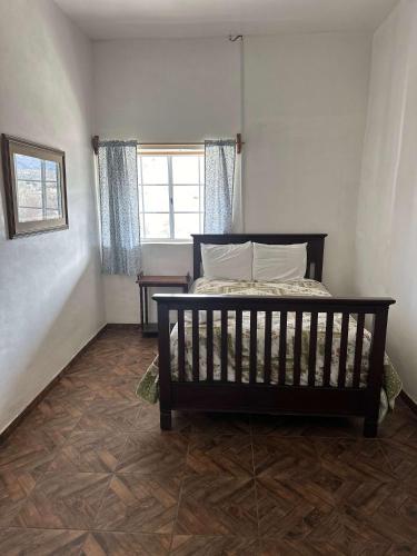 a bedroom with a bed and a window at Casa Lizany in Camalú