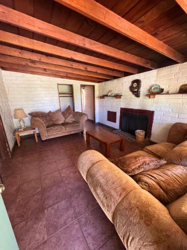 a large living room with couches and a fireplace at Casa Andres in Camalú