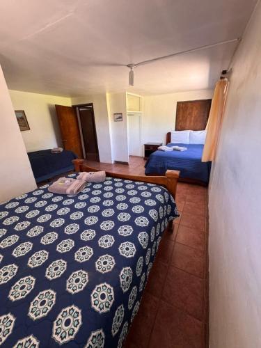 a hotel room with two beds and a bedroom at Casa Andres in Camalú