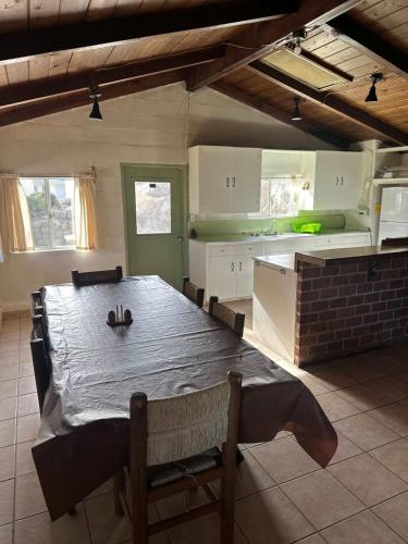 a kitchen with a table and chairs and a kitchen with a table and a kitchen at Rancho Meling Casa Felipe in Camalú