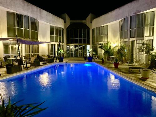 a large blue swimming pool in a building at night at Le Clos de Sangonis in Saint-André-de-Sangonis