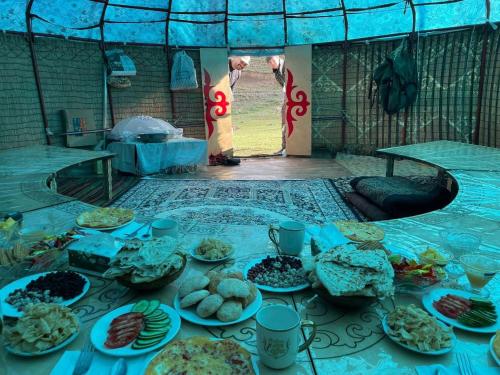 a table with a bunch of food on it at Sonkol-resort in Song-Kul