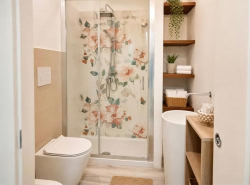a bathroom with a shower with a toilet and a sink at La Via Per Erice in Casa Santa